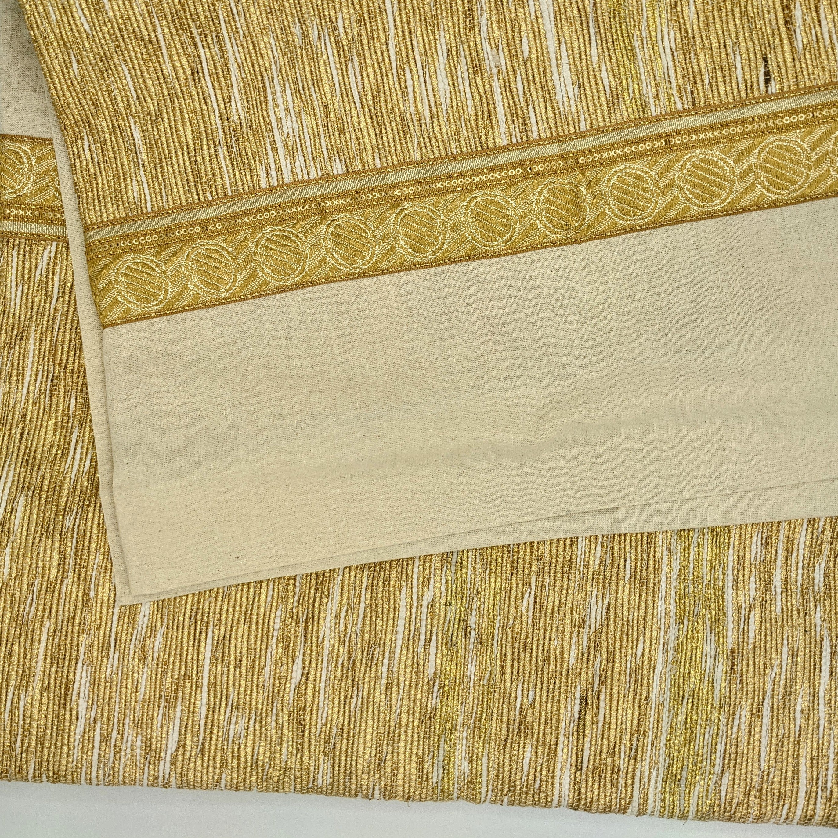 Circular tree skirt made from upcycled golden-brown vintage saree fabric with intricate woven texture and decorative border trim, featuring a center opening with white ribbon ties, photographed on a neutral background