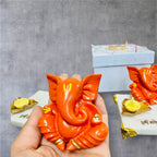 Orange Ganesha on Marble Chowki