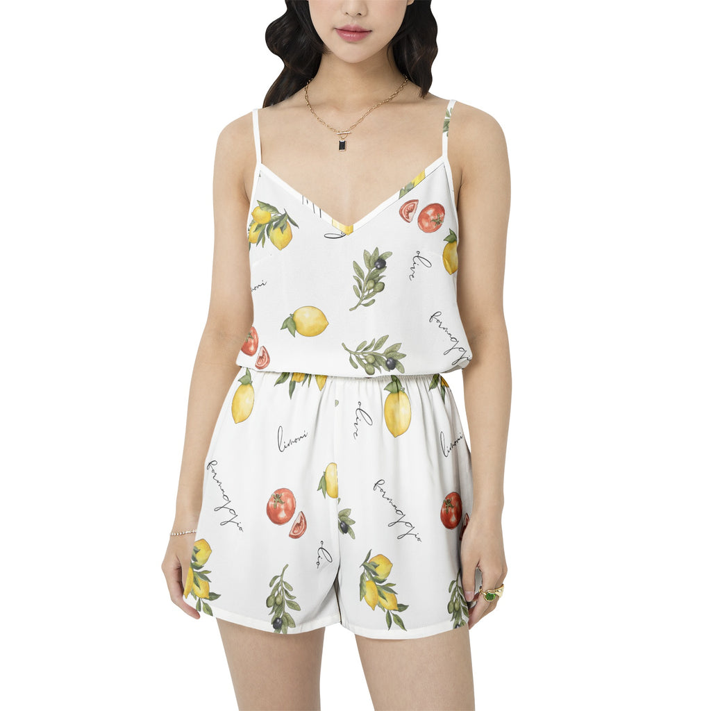 Woman wearing a white romper with fruit print on a white background