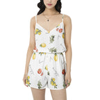 Woman wearing a white romper with fruit print on a white background