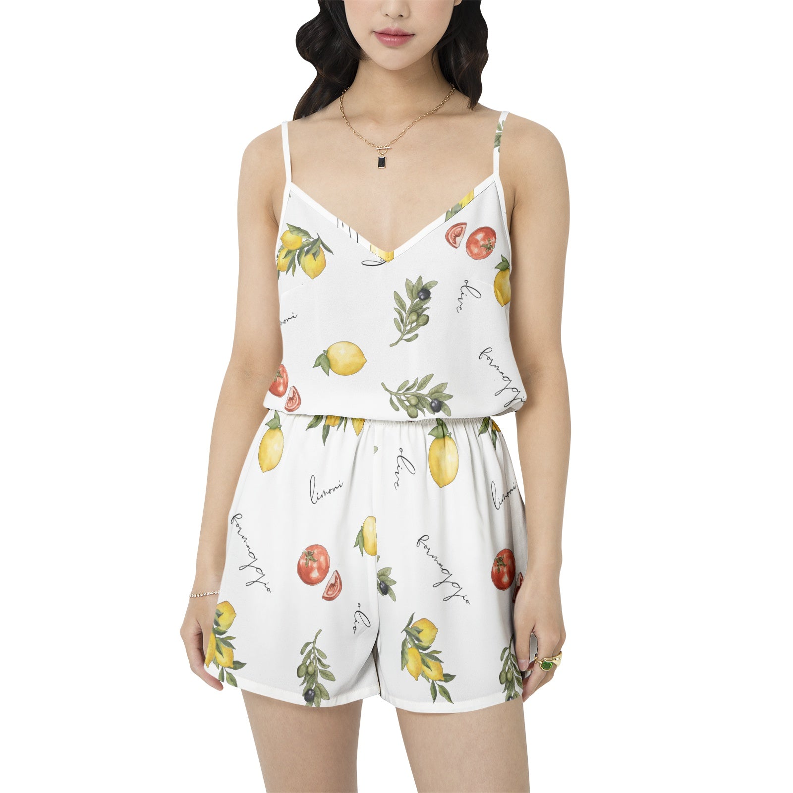Woman wearing a white romper with fruit print on a white background