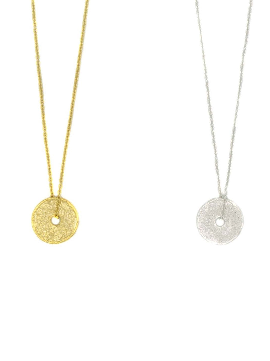 Two necklaces with circular pendants on gold and silver chains against a white background.