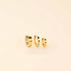 Smooth Tiny Huggie Hoop Earrings by Oh Clementine