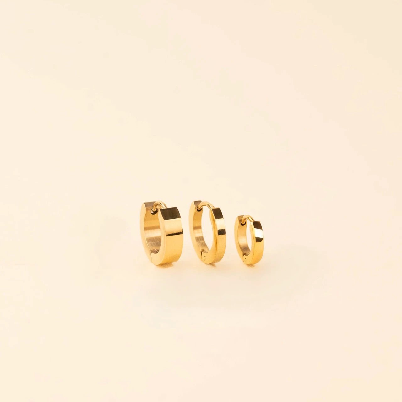 Smooth Tiny Huggie Hoop Earrings by Oh Clementine