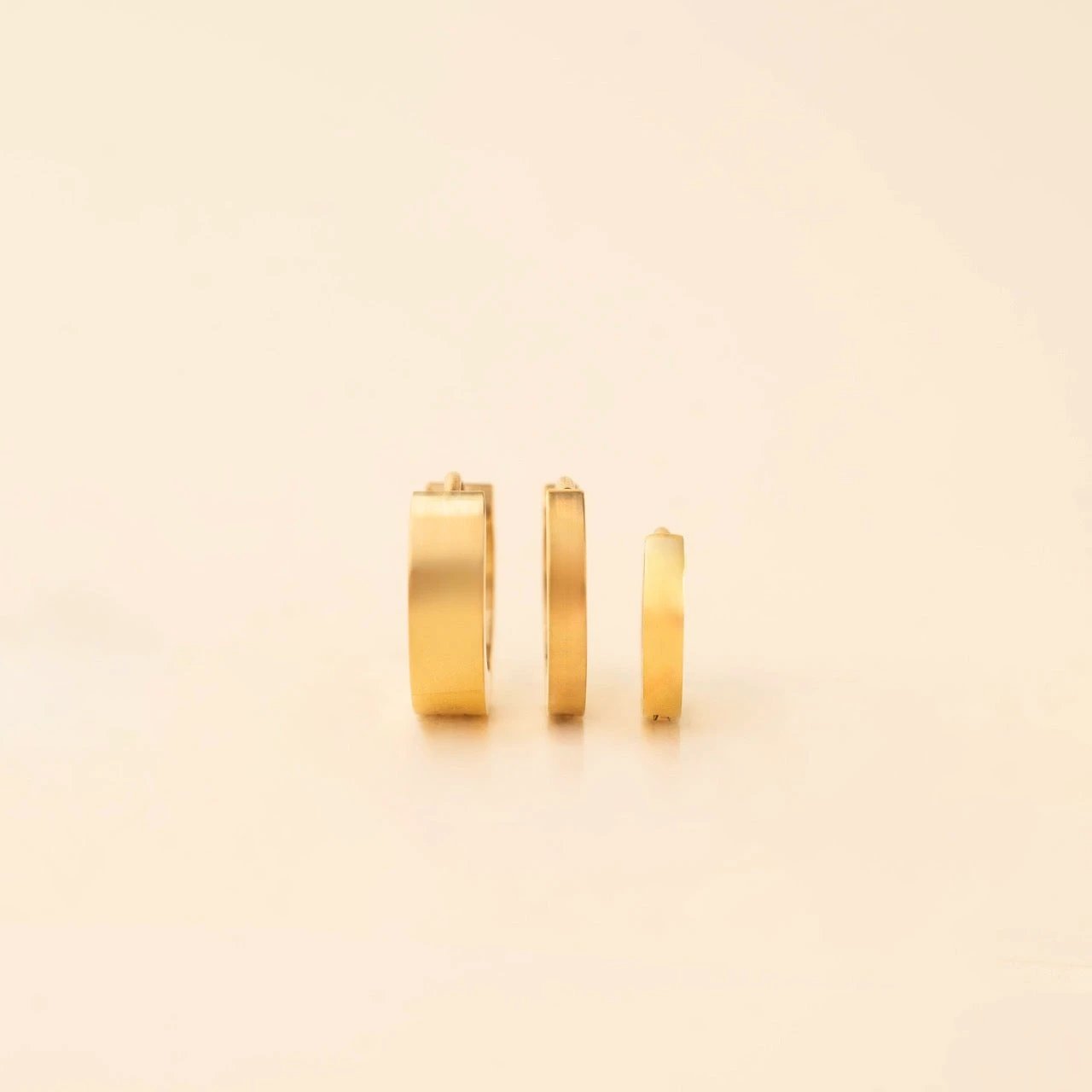Smooth Tiny Huggie Hoop Earrings by Oh Clementine