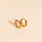 Smooth Tiny Huggie Hoop Earrings by Oh Clementine