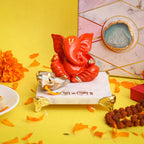 Orange Ganesha on Marble Chowki