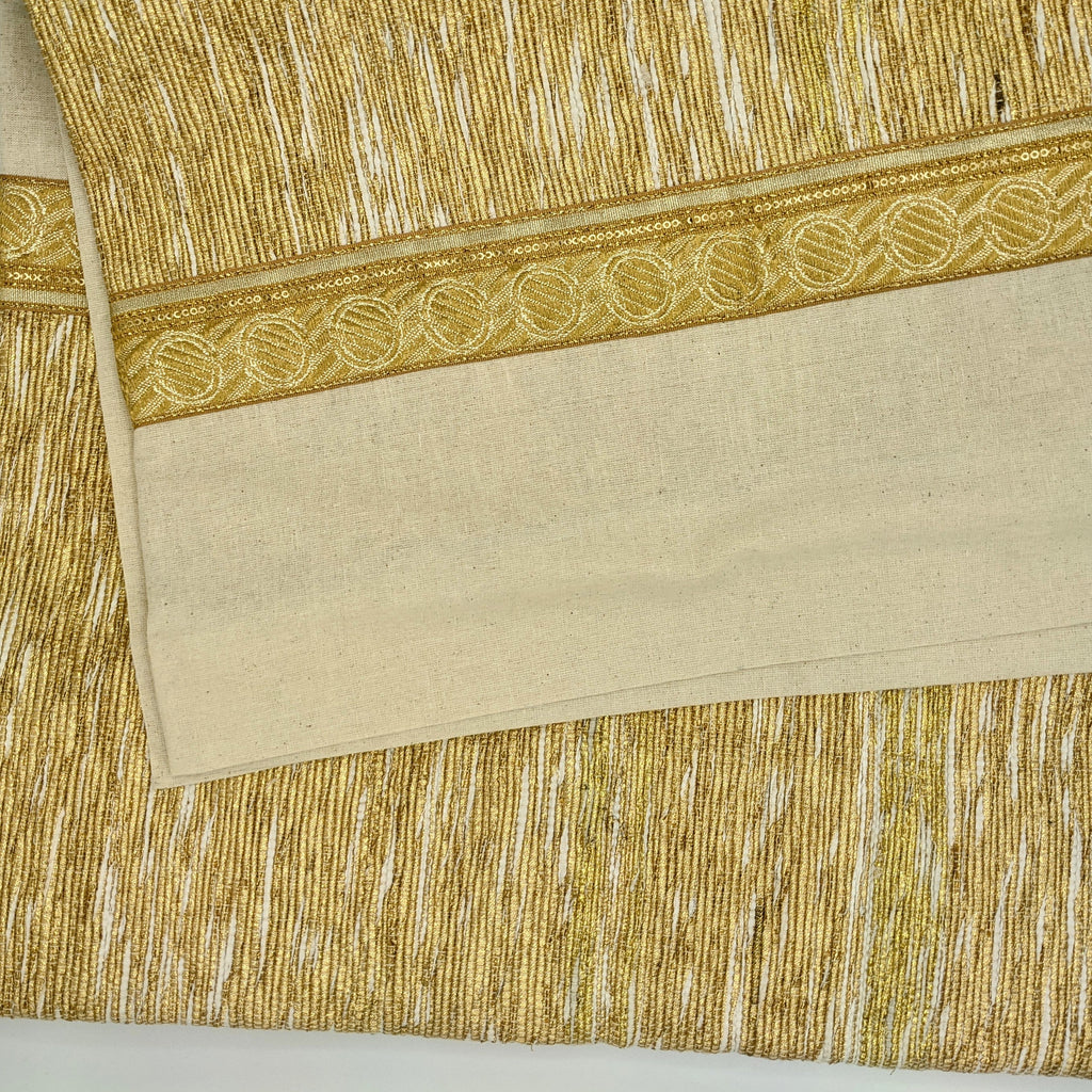 Circular tree skirt made from upcycled golden-brown vintage saree fabric with intricate woven texture and decorative border trim, featuring a center opening with white ribbon ties, photographed on a neutral background