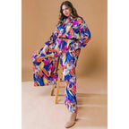 Plus Size Printed Woven Jumpsuit in Blue with Flowers And Leaf Designs | Long Sleeve Romper [Sizes 1X-3X] by The Bullish Store