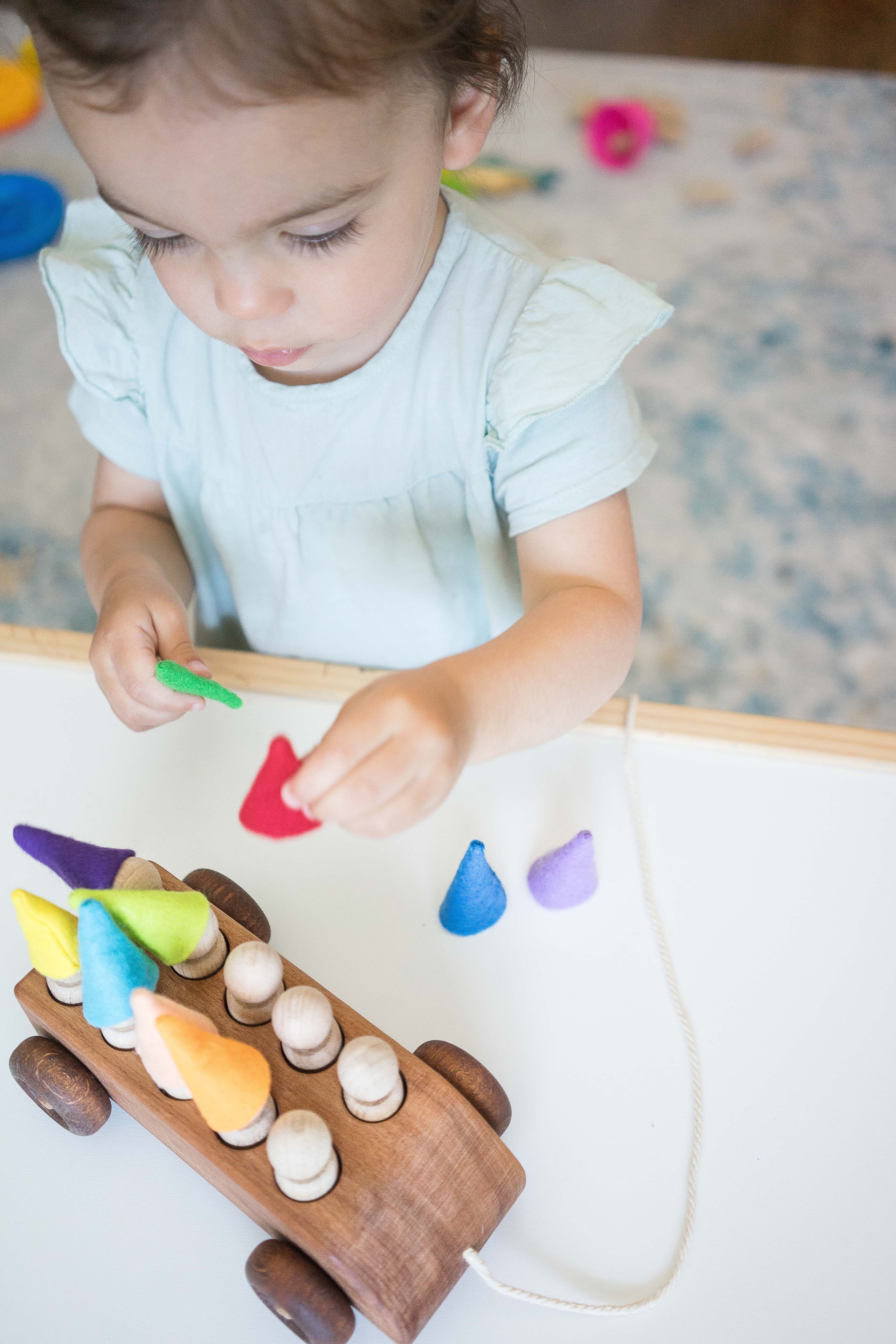 Wooden Toy Car with ten Pegs in Multi-Colored Hats