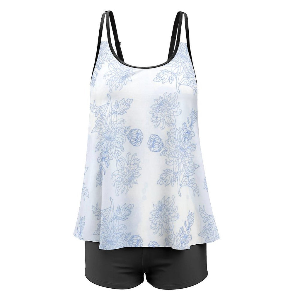 White tank top with blue floral pattern and black shorts on a white background