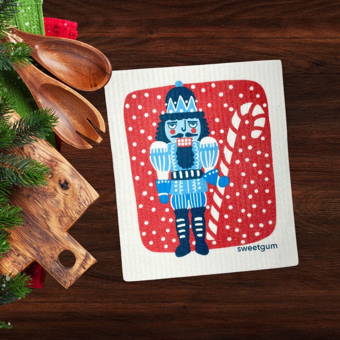 Blue Nutcracker Swedish Dishcloth | Red background with snow Swedish Dishcloths La Vie Bien Blue Nutcracker Swedish Dishcloth | Red background with snow