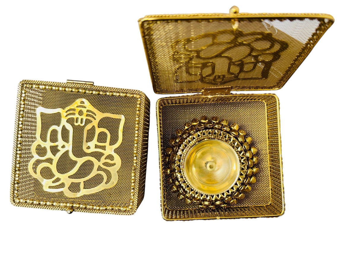 Brass Akhand Diya's with Ghungroo Base in Metal Gift Box with Ganesha Decal La Vie Bien Brass Akhand Diya's with Ghungroo Base in Metal Gift Box with Ganesha Decal