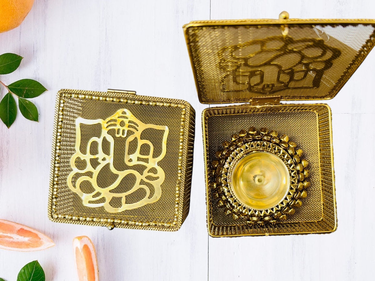 Brass Akhand Diya's with Ghungroo Base in Metal Gift Box with Ganesha Decal La Vie Bien Brass Akhand Diya's with Ghungroo Base in Metal Gift Box with Ganesha Decal