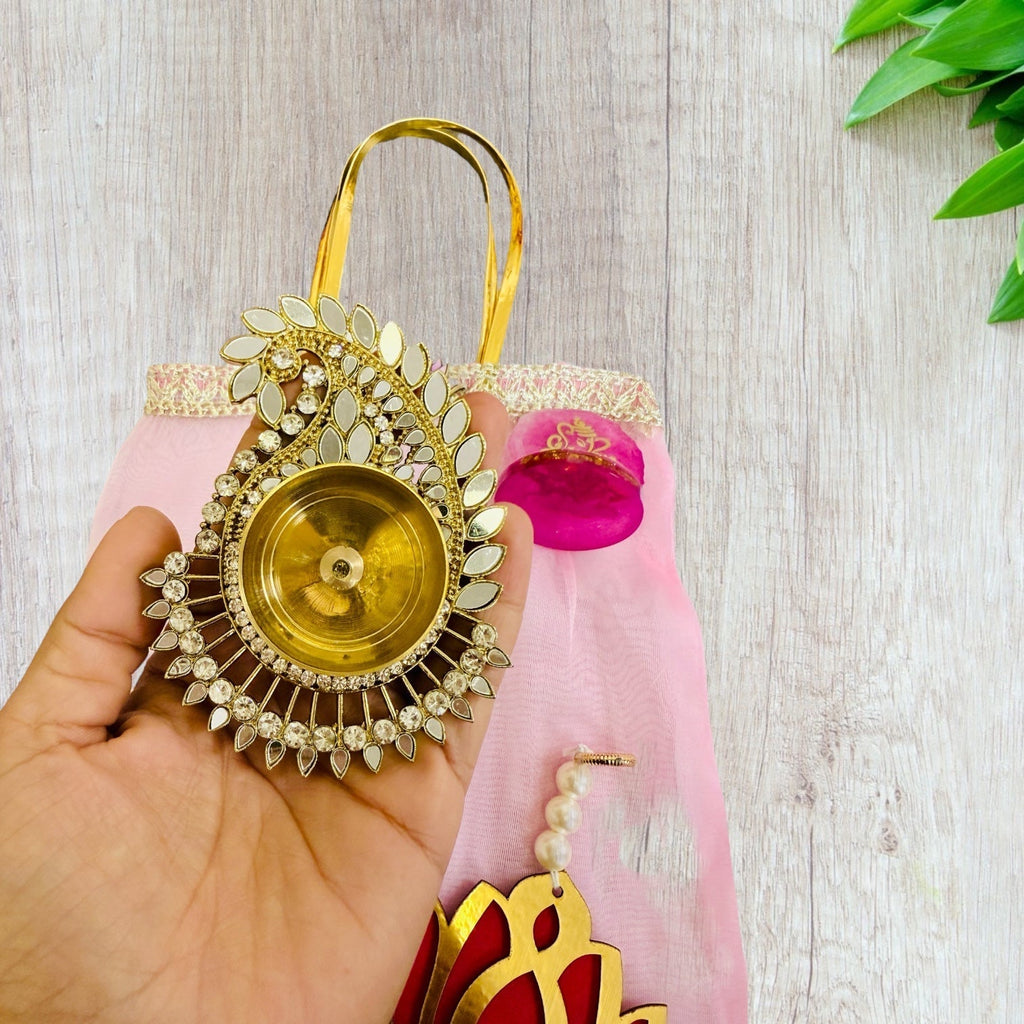 Combo of Akhand Diya, Resin Ganesha, Lotus Hanging in Organza Bag La Vie Bien Combo of Akhand Diya, Resin Ganesha, Lotus Hanging in Organza Bag