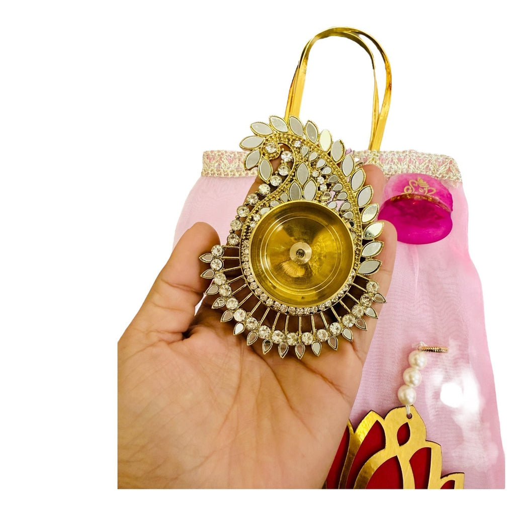Combo of Akhand Diya, Resin Ganesha, Lotus Hanging in Organza Bag La Vie Bien Combo of Akhand Diya, Resin Ganesha, Lotus Hanging in Organza Bag