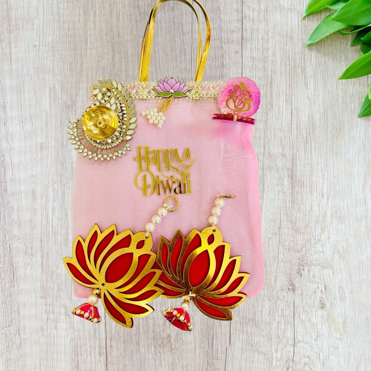 Combo of Akhand Diya, Resin Ganesha, Lotus Hanging in Organza Bag La Vie Bien Combo of Akhand Diya, Resin Ganesha, Lotus Hanging in Organza Bag