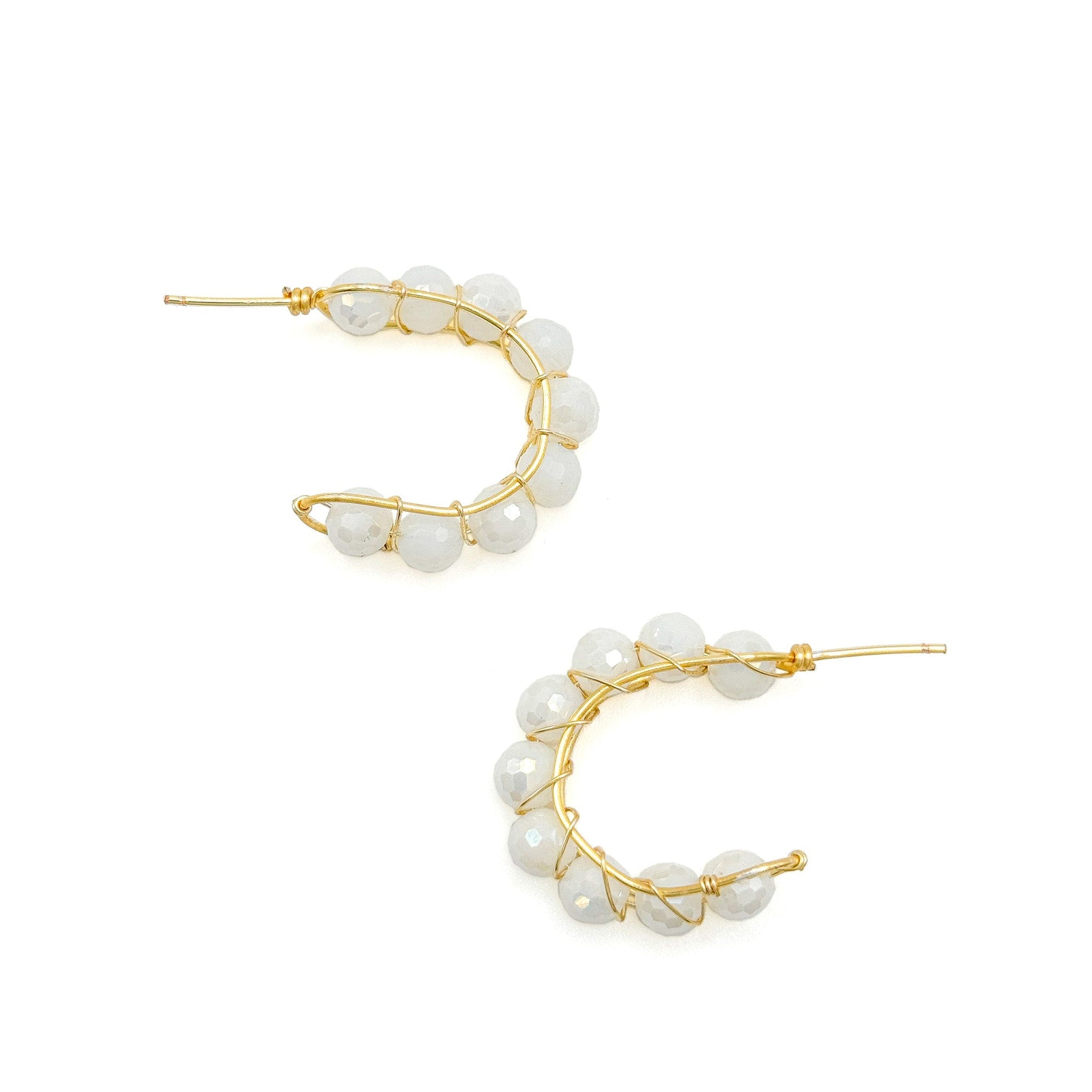 A pair of gold earrings for pierced ears with white beads
