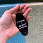 Department of Redundancy Department Motel Style Keychain in Black by The Bullish Store
