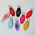 Department of Redundancy Department Motel Style Keychain in Black by The Bullish Store