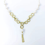 Empowering pearl and gold chain y necklace with tassel detail by Alegria Accessories Inc