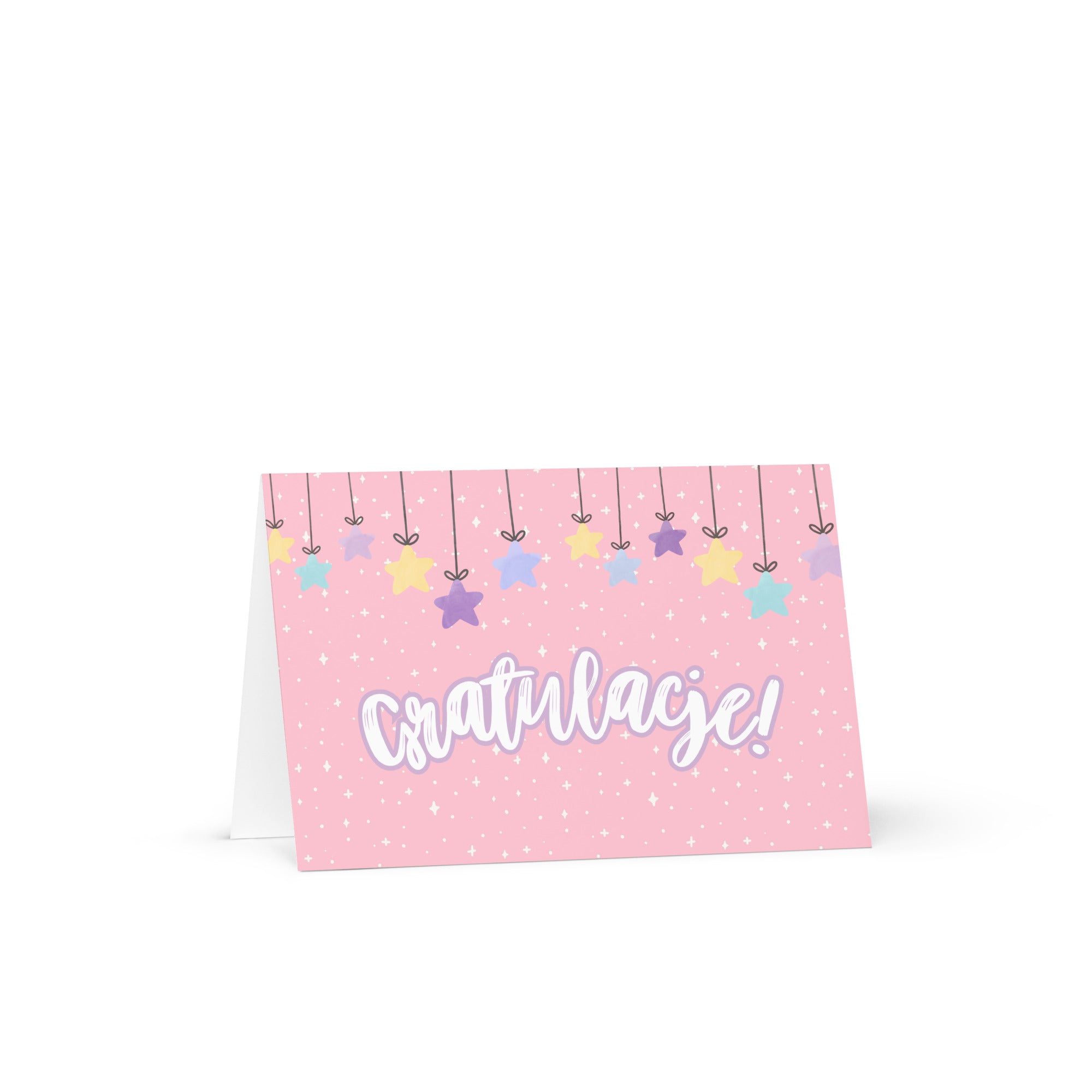 Polish greeting card with pink background featuring "Gratulacje!" text in white script lettering, decorated with hanging colorful stars and small sparkle details throughout