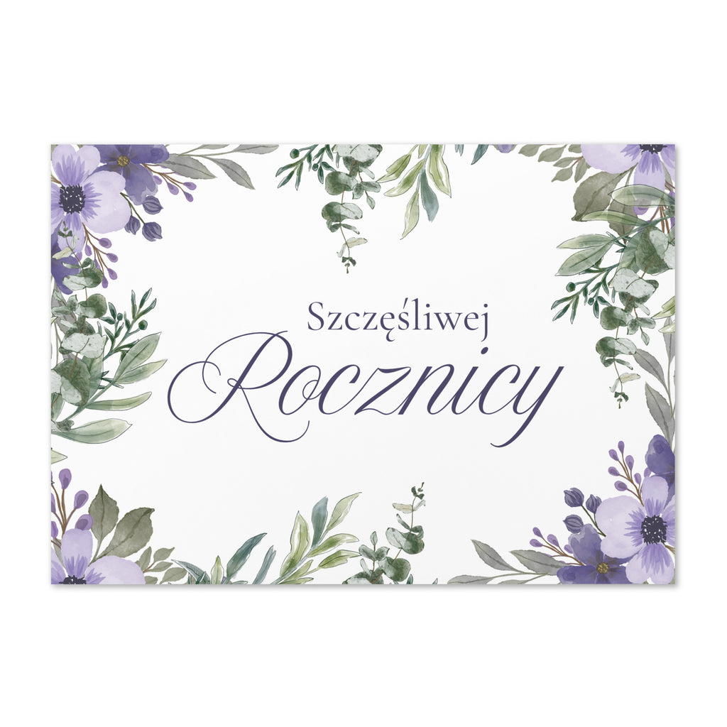 Polish anniversary greeting card featuring "szczęśliwej rocznicy" text in elegant script on white background, decorated with watercolor purple flowers and green botanical leaves in corner arrangement