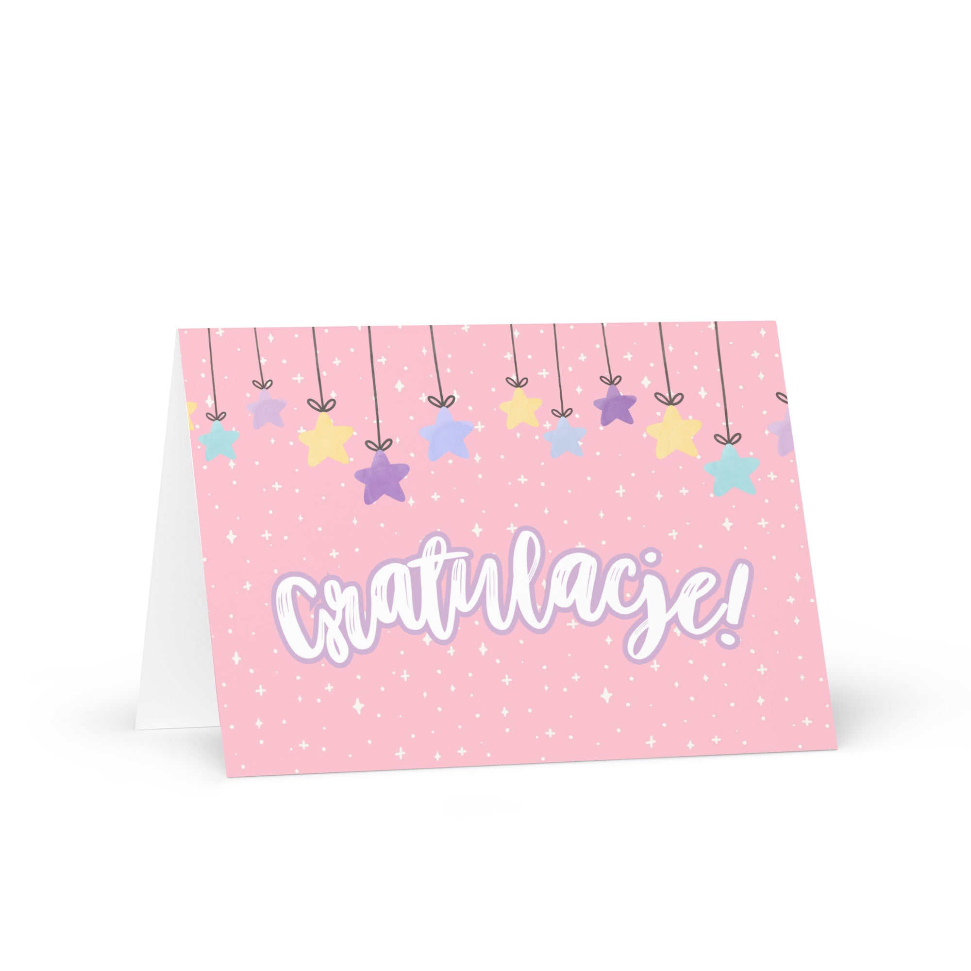 Polish greeting card with pink background featuring "Gratulacje!" text in white script lettering, decorated with hanging colorful stars and small sparkle details throughout
