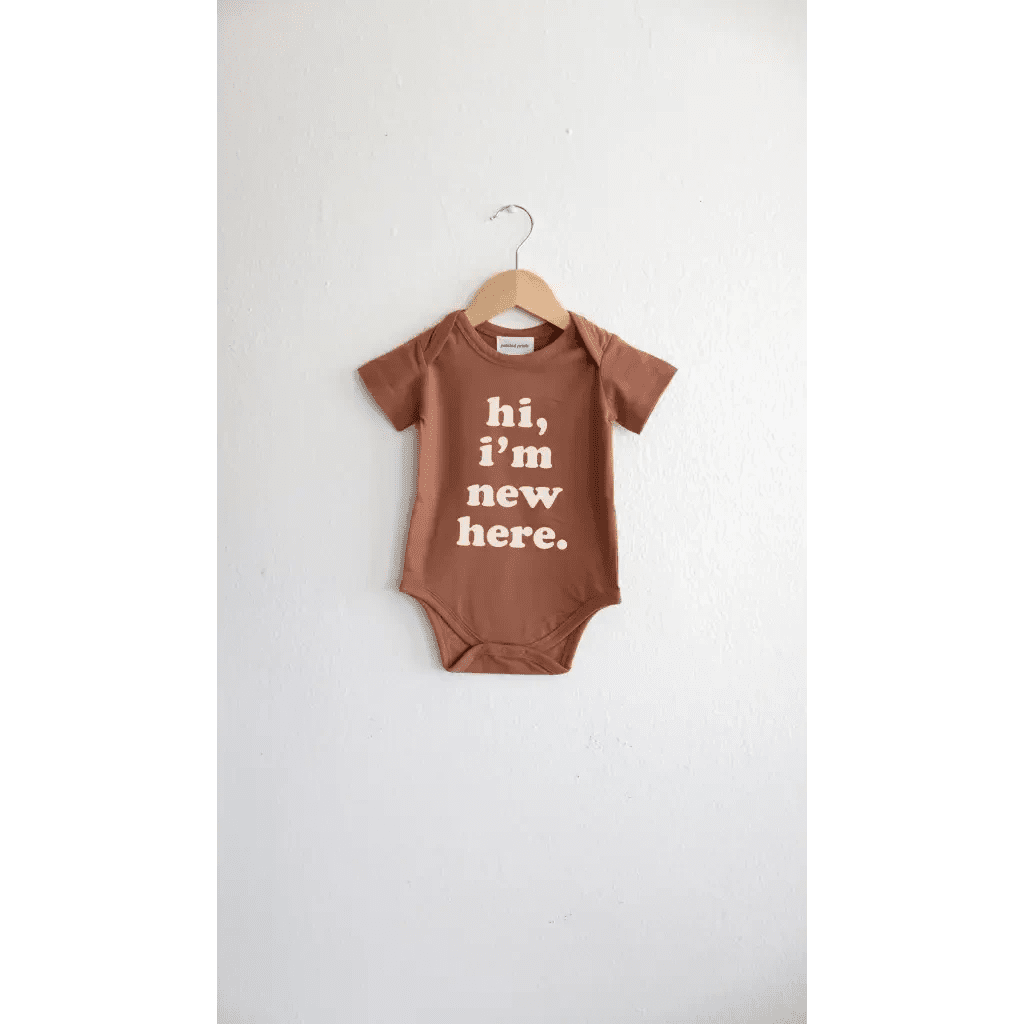 Hi, I'm New Here Baby Onesie in Almond by Polished Prints