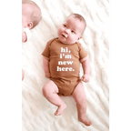 Hi, I'm New Here Baby Onesie in Almond by Polished Prints