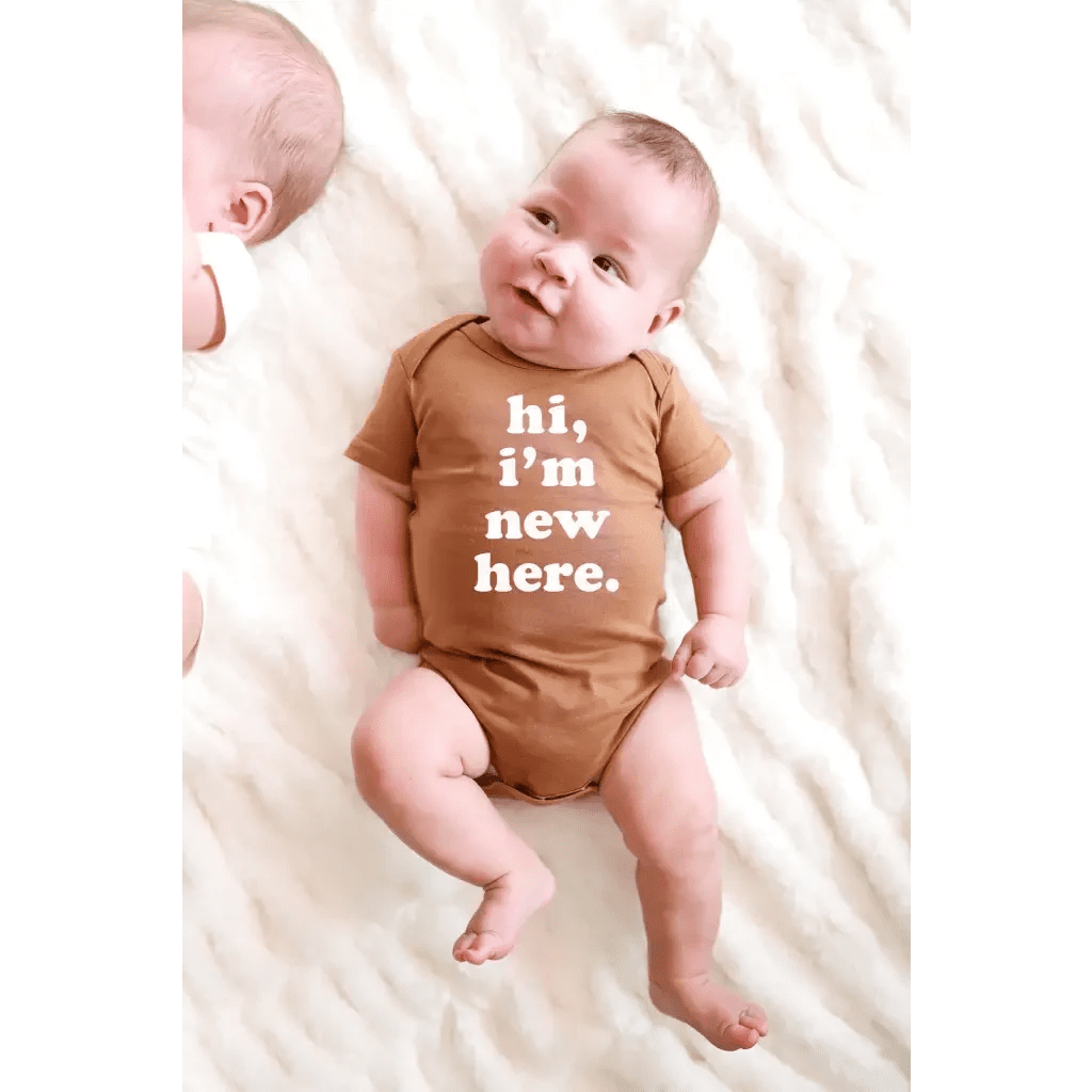 Hi, I'm New Here Baby Onesie in Almond by Polished Prints