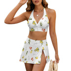 Woman wearing a white bikini set with fruit print on a white background