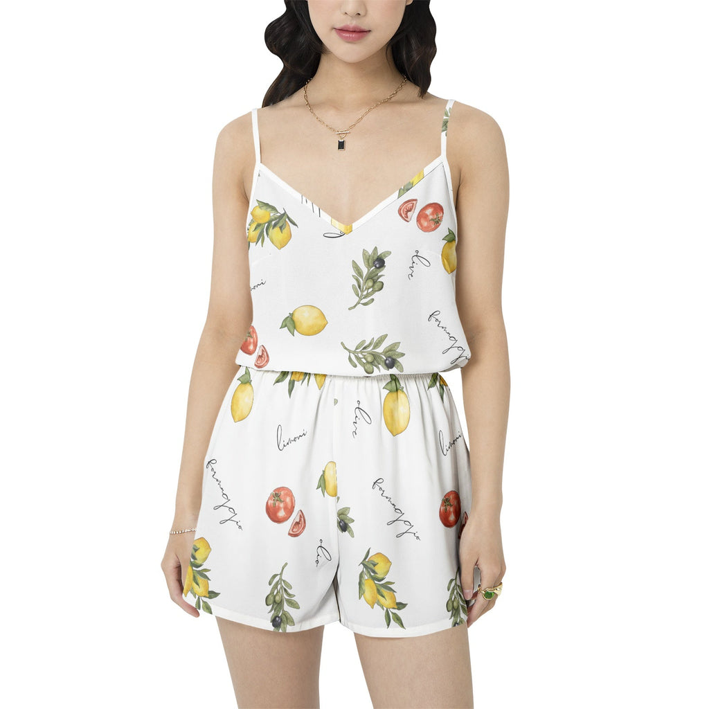 Woman wearing a white romper with fruit print on a white background