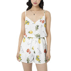Woman wearing a white romper with fruit print on a white background