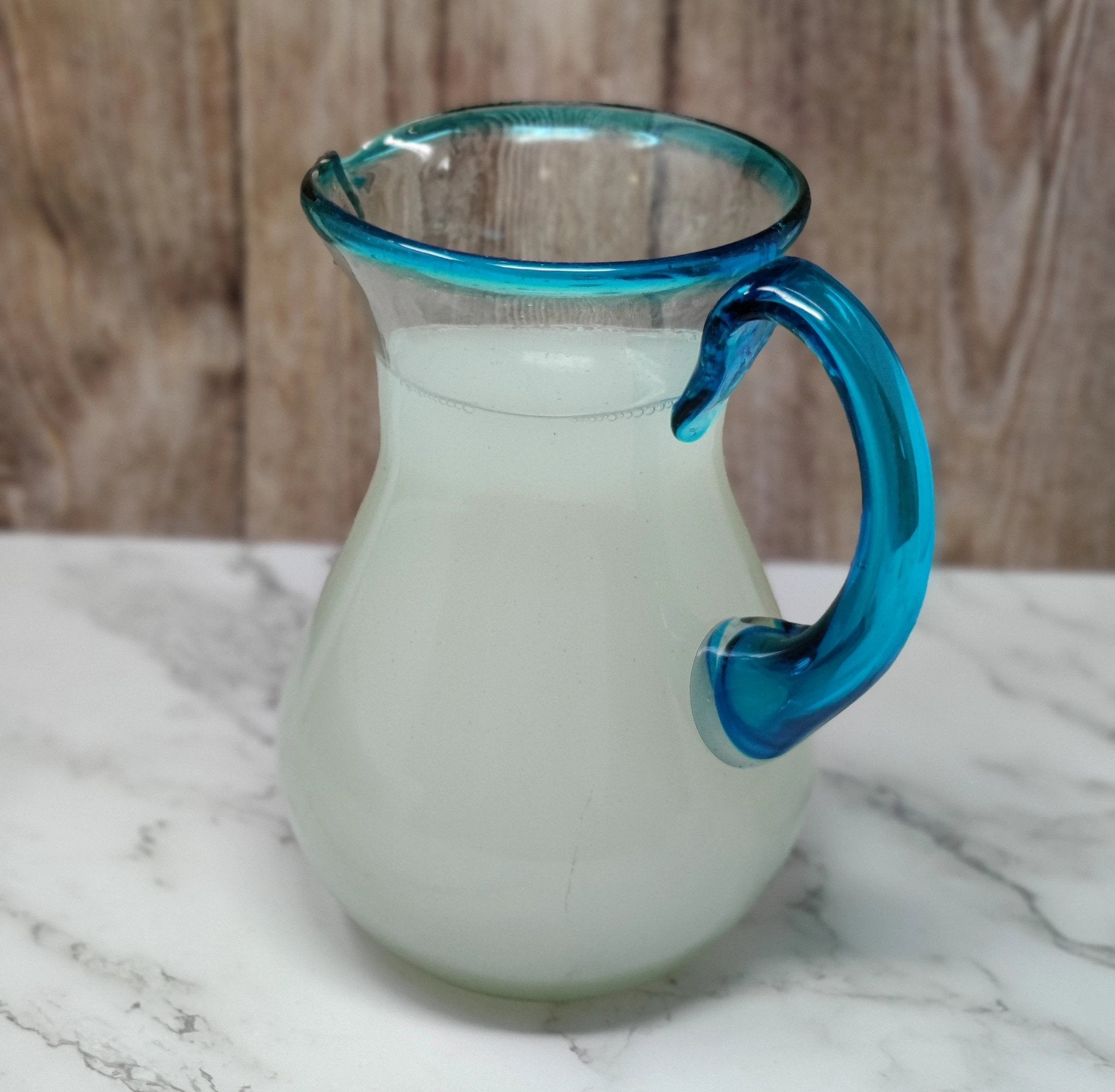 Mexican Hand Blown Glass Pitcher – Aqua Rim and Handle (84 oz) by Dos Sueños