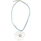 Petals silver flower and pearl pendant on a blue suede necklace by Alegria Accessories Inc