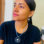Petals silver flower and pearl pendant on a blue suede necklace by Alegria Accessories Inc