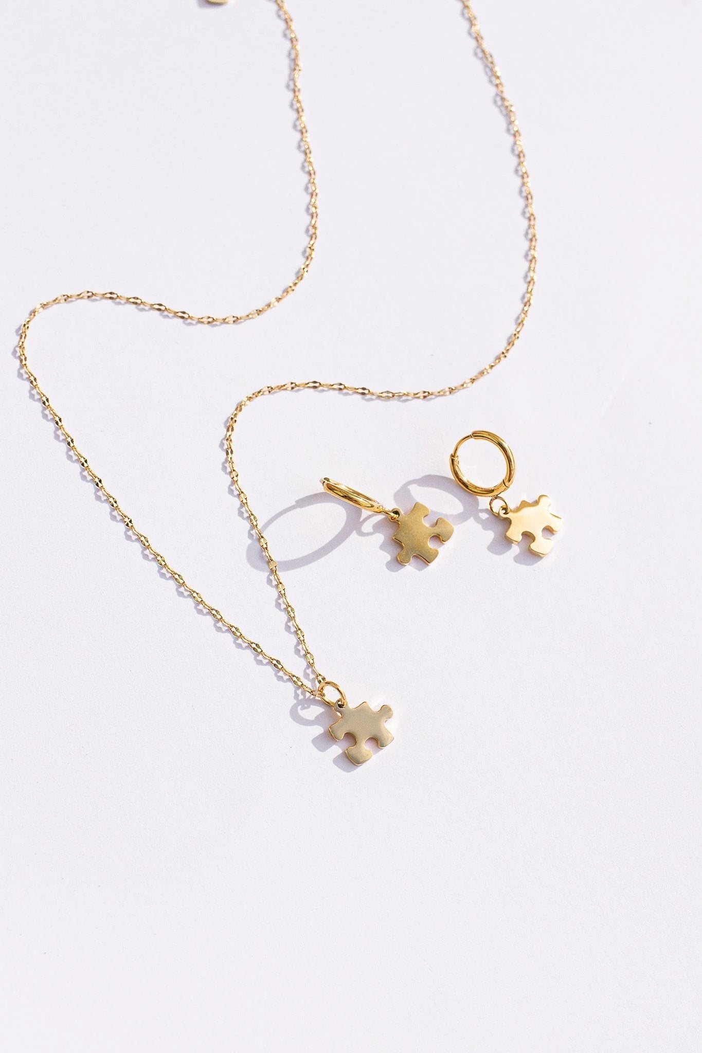 Puzzle Piece Huggie Hoops by Rose & Clay