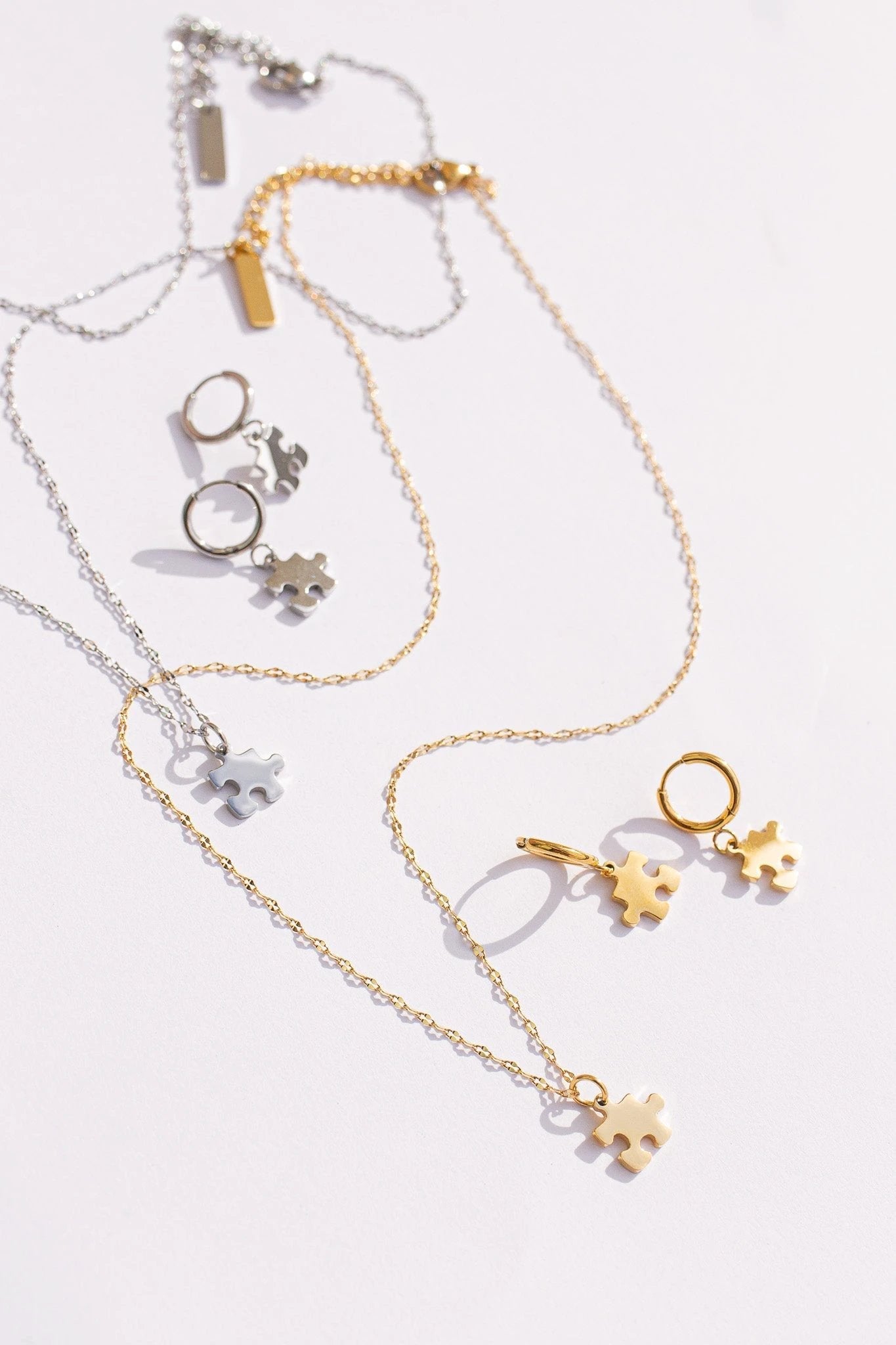 Puzzle Piece Huggie Hoops by Rose & Clay