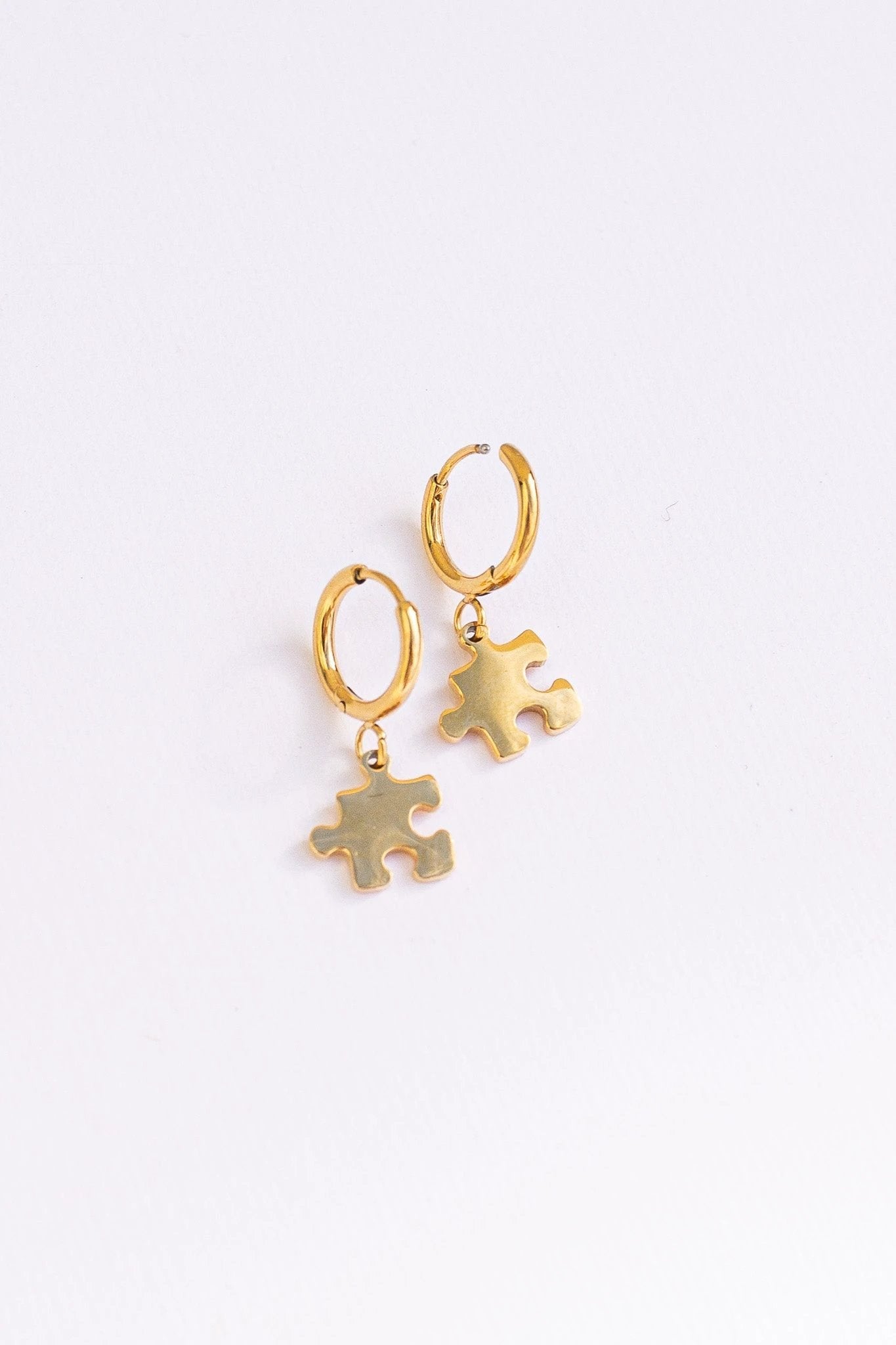 Puzzle Piece Huggie Hoops by Rose & Clay