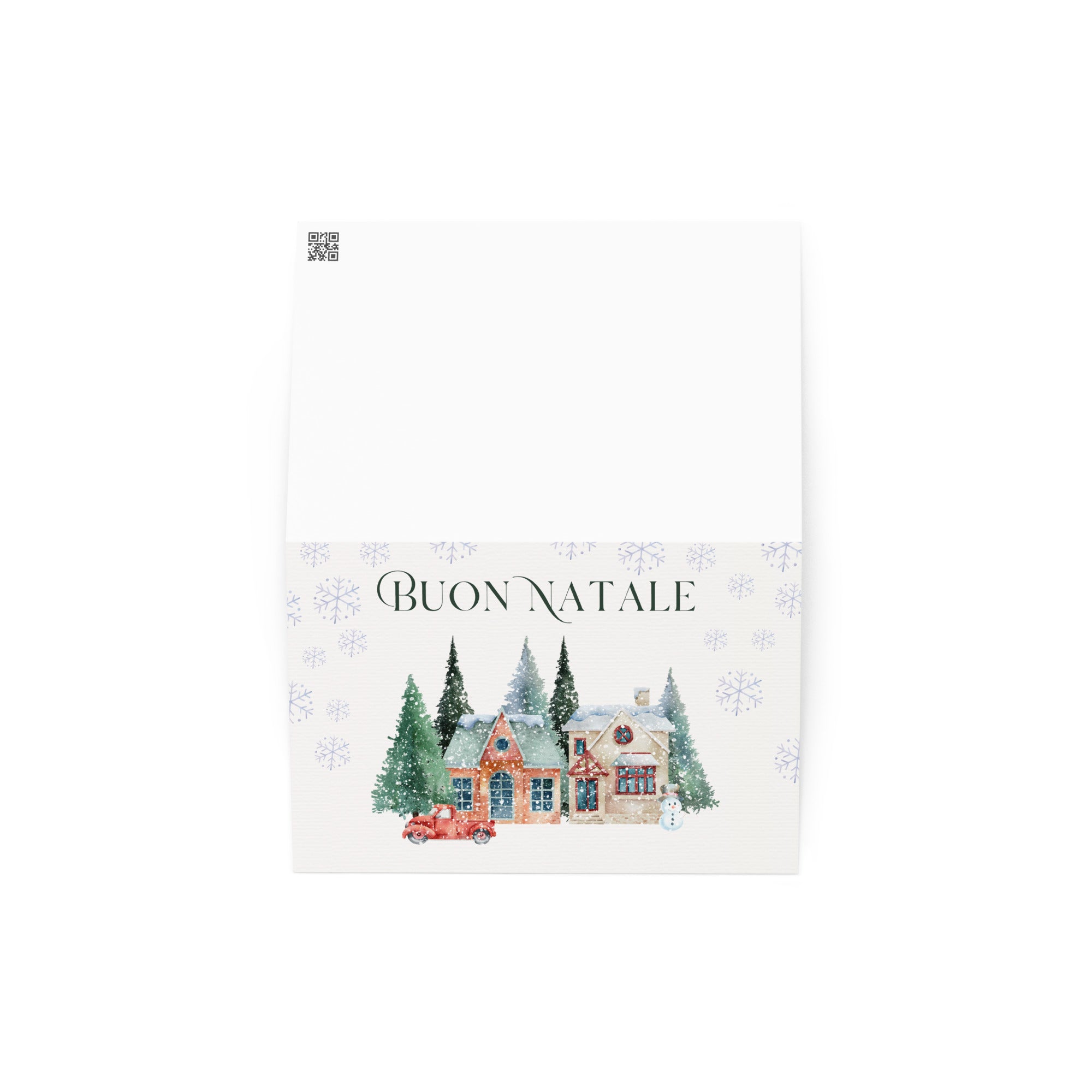 Italian Christmas greeting card featuring "Buon Natale" text with watercolor illustration of snowy village scene with cottages, pine trees, snowman, and vintage truck surrounded by delicate snowflake pattern