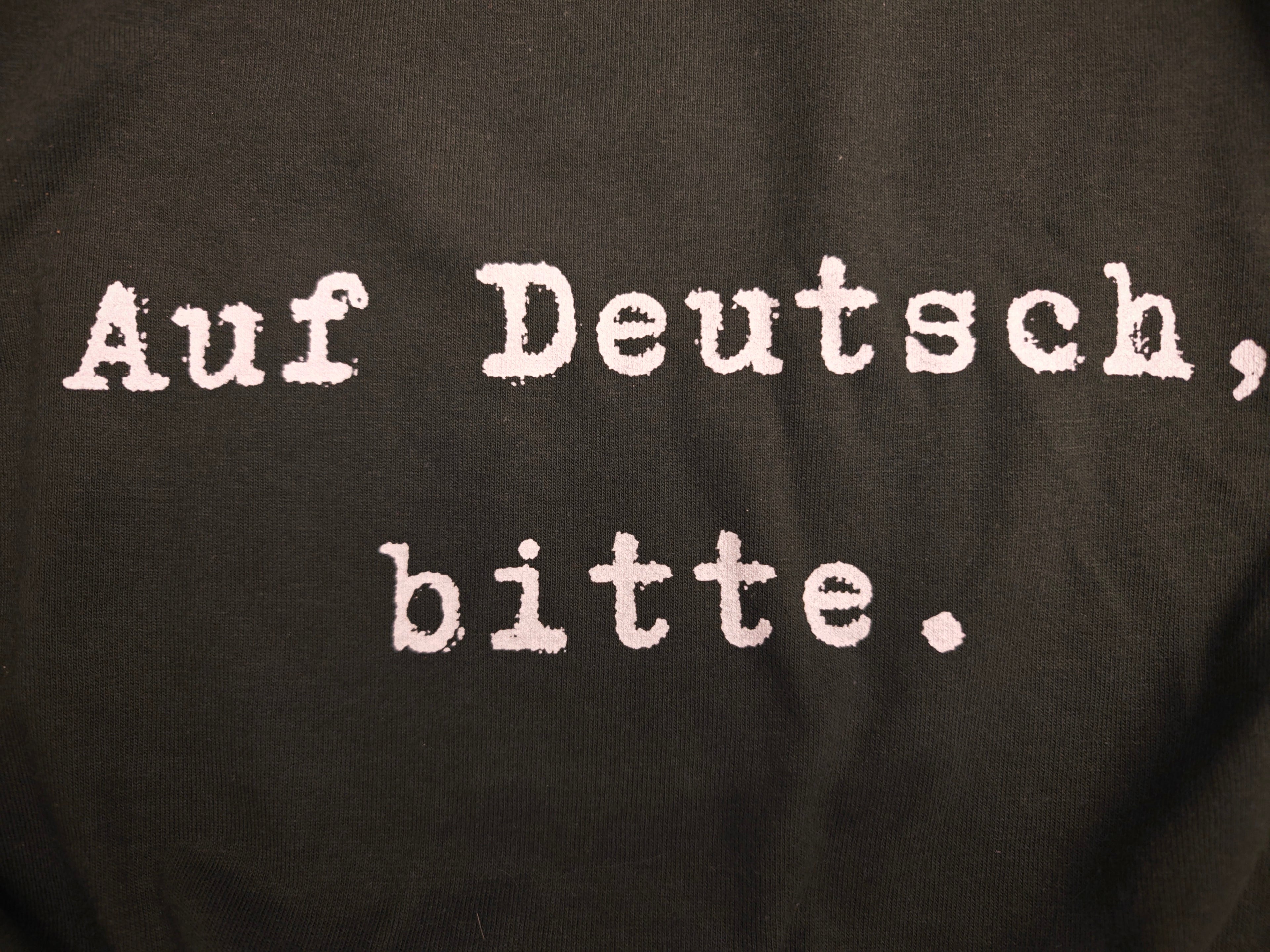 Auf Deutsch, bitte. German Language Tee Shirt, typewriter font Gildan 5000