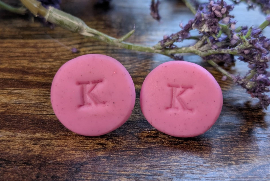 Pink K initial stud earrings