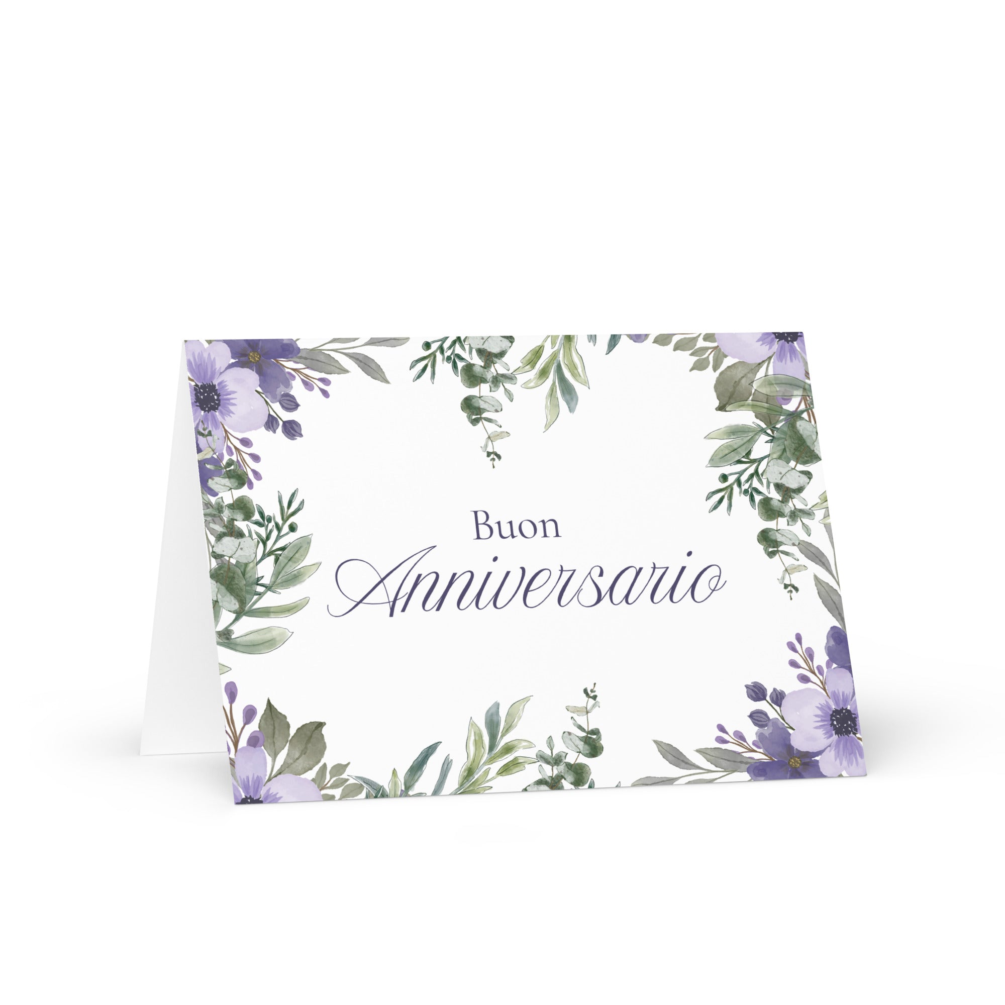 Italian anniversary greeting card featuring "Buon Anniversario" text in elegant script on white background, decorated with watercolor purple flowers and green botanical leaves in corner arrangement