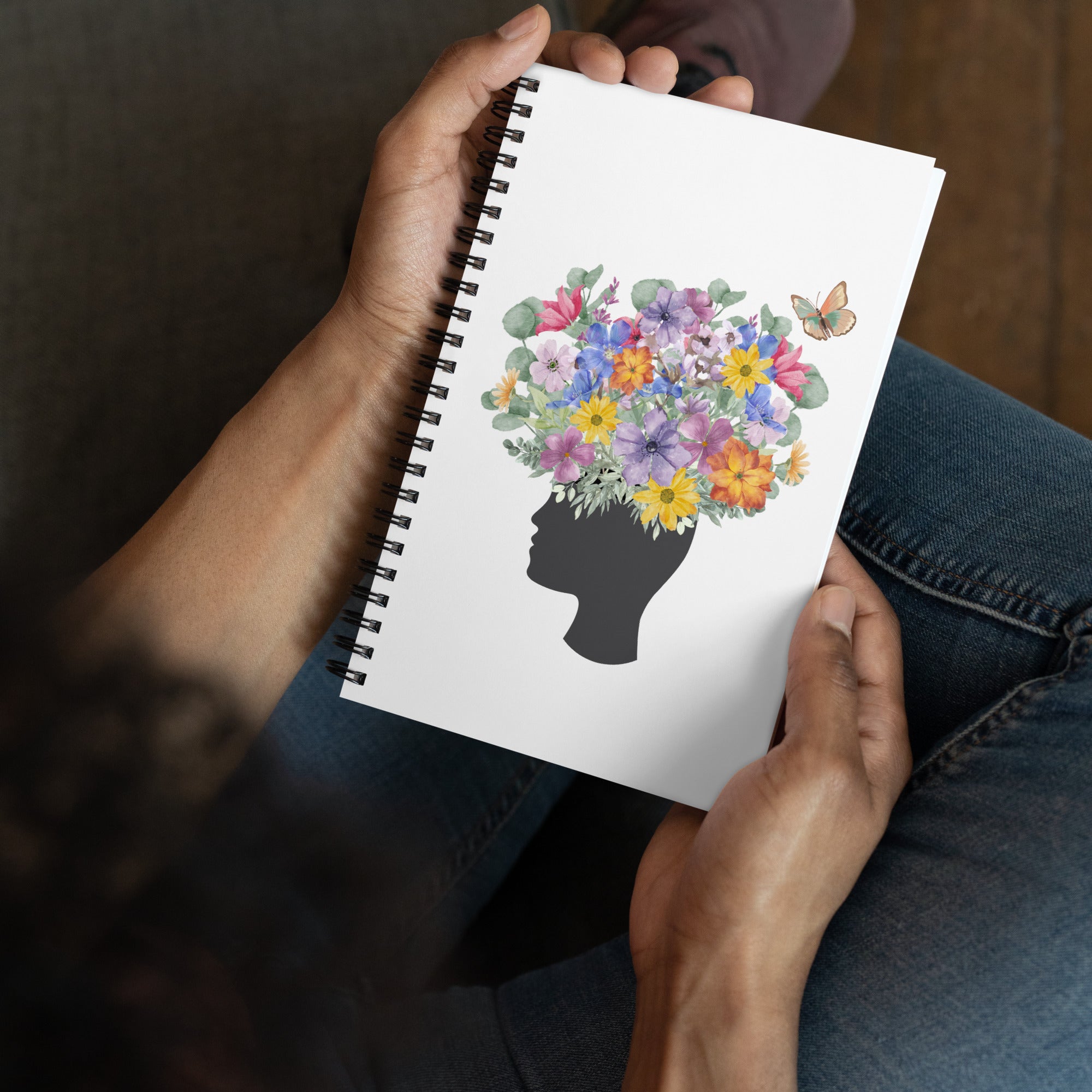 An image of the Spiral dotted notebook and a graphic of a head with flowers coming out of the top