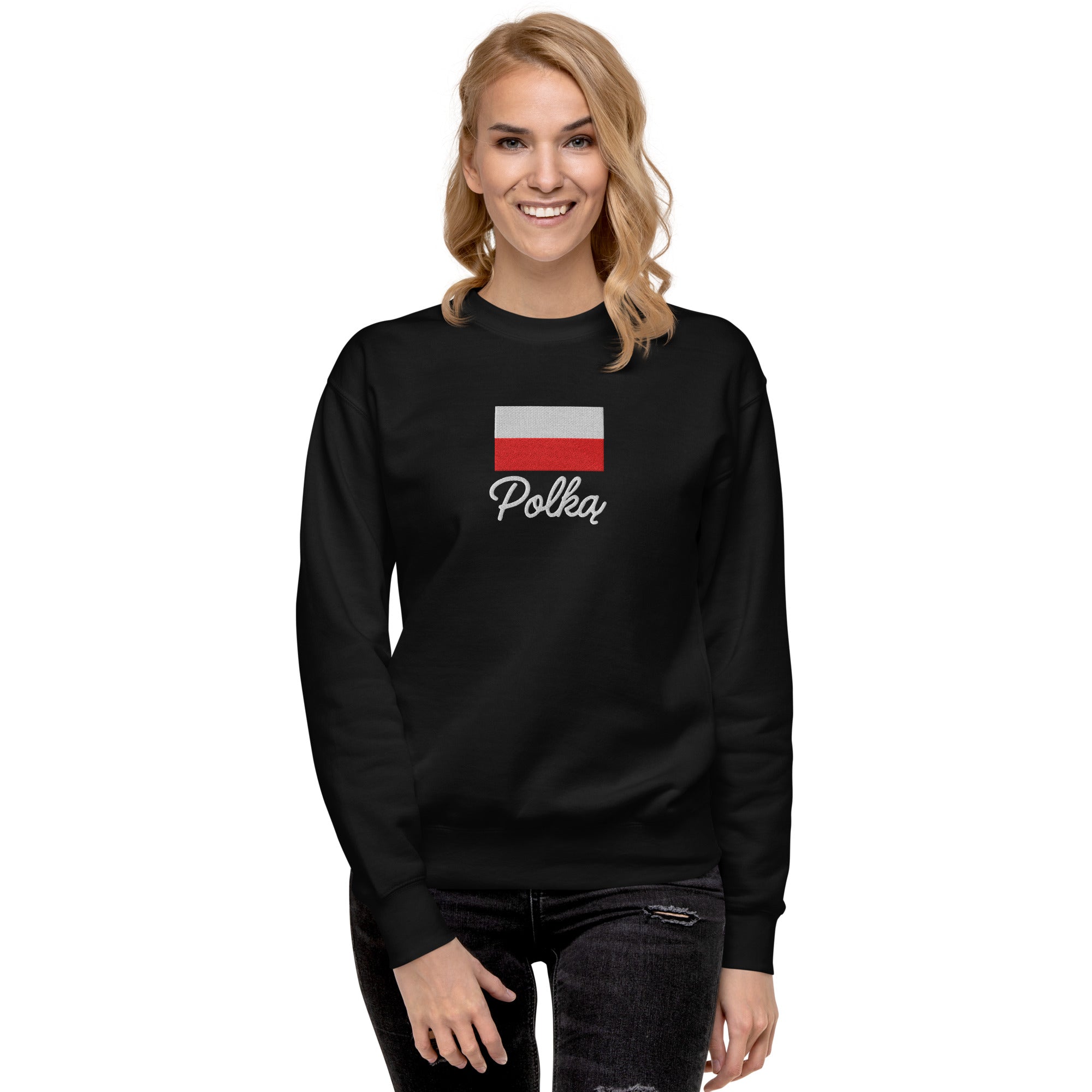 Black crew neck sweatshirt modeled on person, featuring embroidered Polish flag in white and red colors above white embroidered text "Polka" in script font