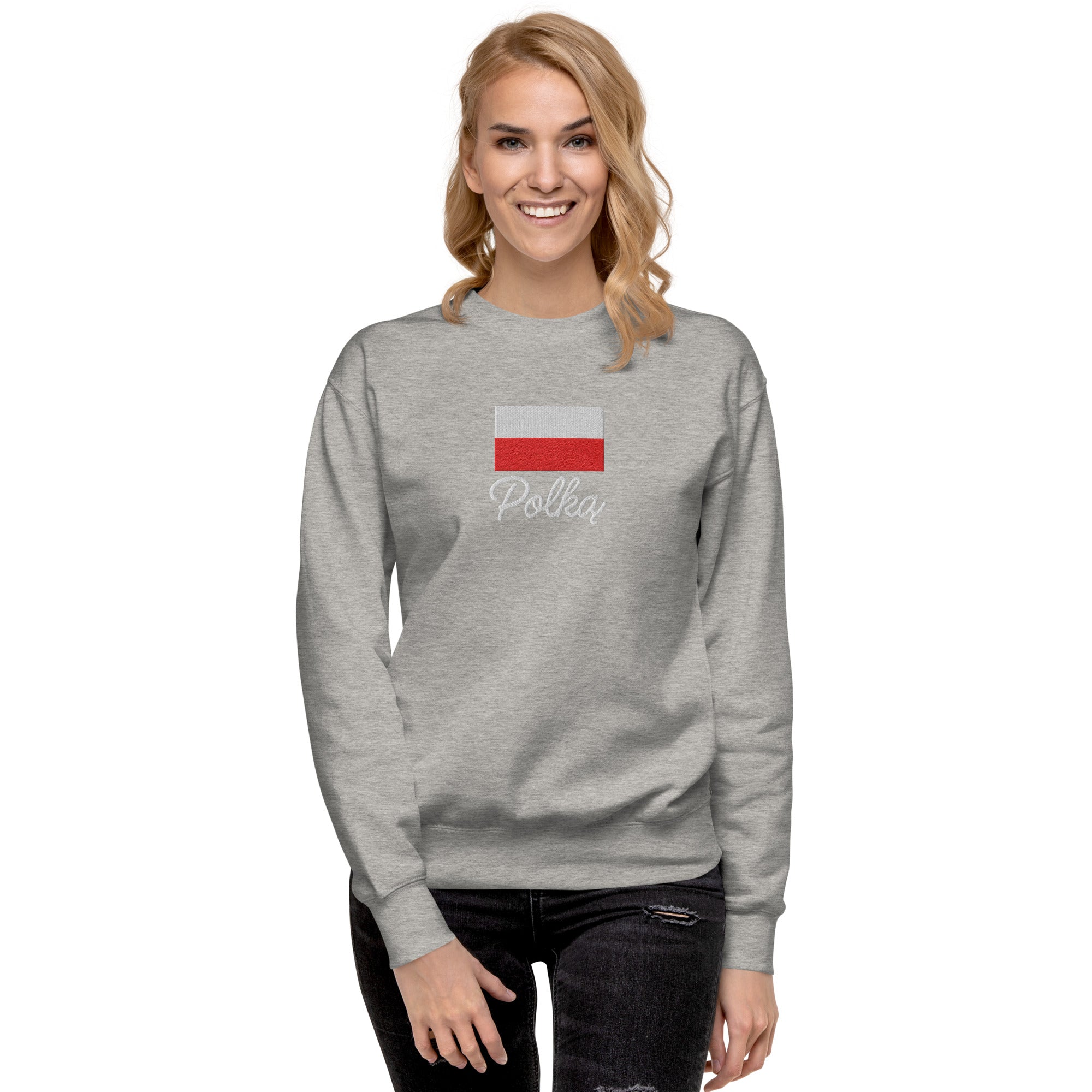 Light gray crew neck sweatshirt modeled on person, featuring embroidered Polish flag in white and red colors above white embroidered text "Polka" in script font