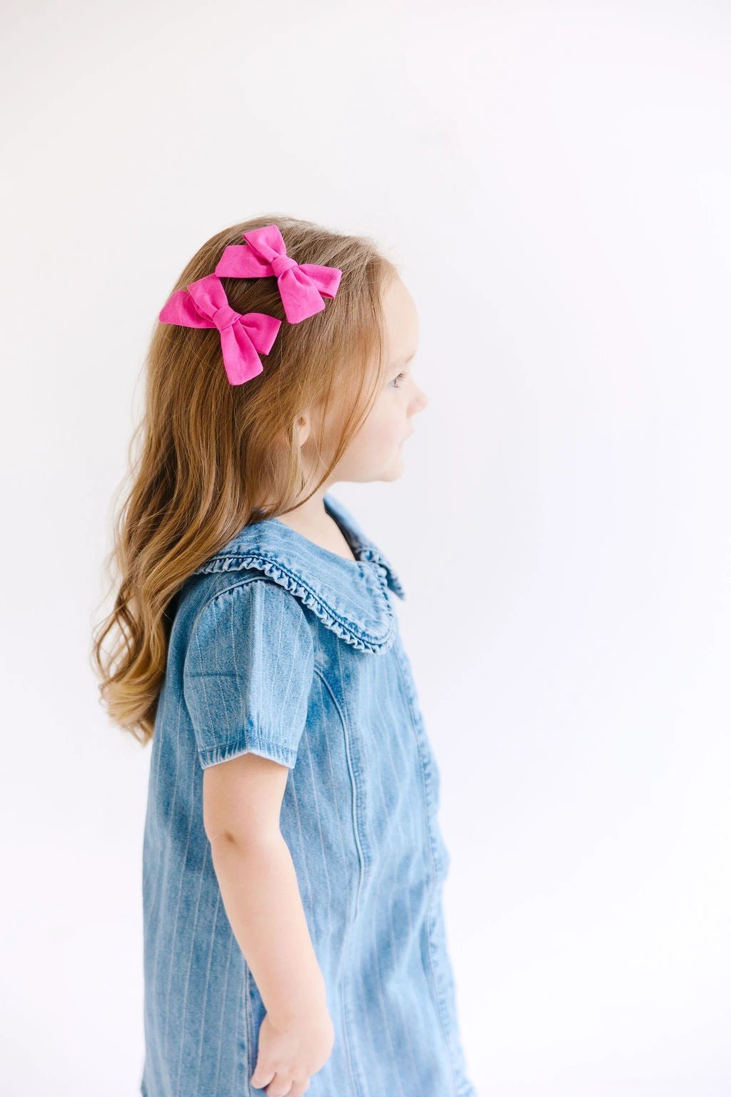 White Mini Solid Pinwheel Pigtail Bow Set by Evie Pearl Handmade