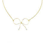 With a Bow necklace by Alegria Accessories Inc