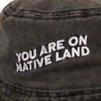 'YOU ARE ON NATIVE LAND' BUCKET HAT by Urban Native Era